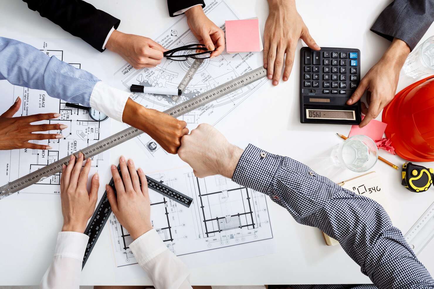 businessmen-hands-white-table-with-documents-drafts_176420-341