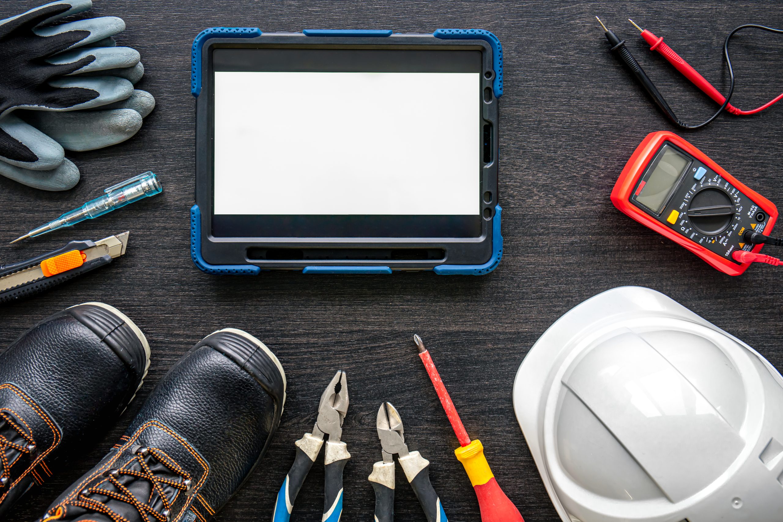 Composition with digital tablet and electrician work items.